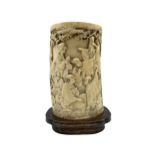 19th century Japanese ivory tusk vase finely carved with a continuous scene of figures gathered outs