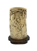 19th century Japanese ivory tusk vase finely carved with a continuous scene of figures gathered outs