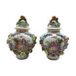 Pair of early 20th century Dresden porcelain floral encrusted vases and covers