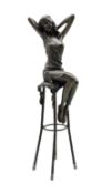 Art Deco style bronze figure of a lady with hands raised behind her head