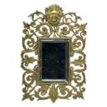 Victorian wall mirror with bevelled plate in a pierced brass frame with foliage and mask finial 39cm