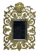 Victorian wall mirror with bevelled plate in a pierced brass frame with foliage and mask finial 39cm