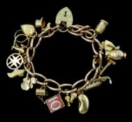 Gold link bracelet with heart locket claps and twenty gold charms including thimble