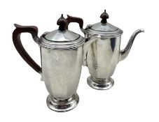 Silver small coffee pot and matching hot milk jug of panel sided design with stained wood handles a