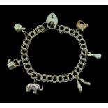 Gold double link curb bracelet with six gold charms including horses head