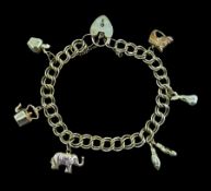 Gold double link curb bracelet with six gold charms including horses head