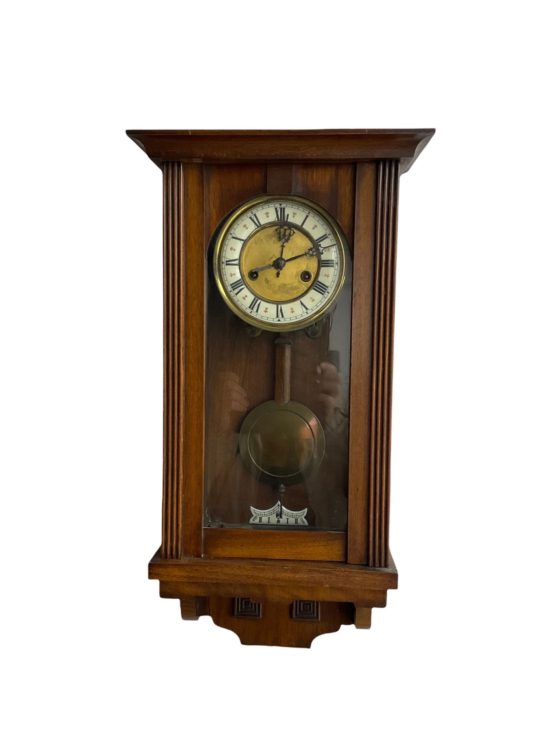 A late 19th century German spring driven wall clock in a mahogany case