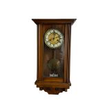 A late 19th century German spring driven wall clock in a mahogany case