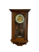 A late 19th century German spring driven wall clock in a mahogany case
