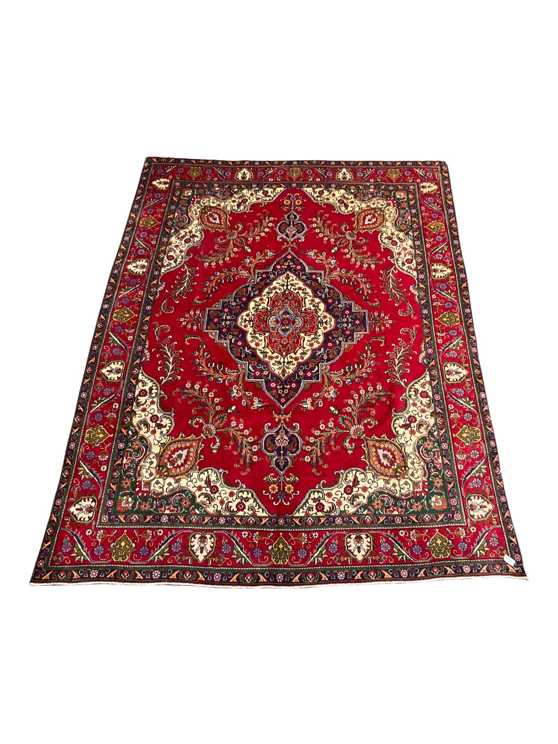 Hand knotted Persian rug from Tabriz region with red field
