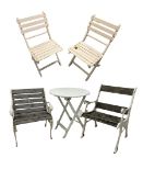 Near pair of painted cast iron garden chairs with wooden slat back and seat