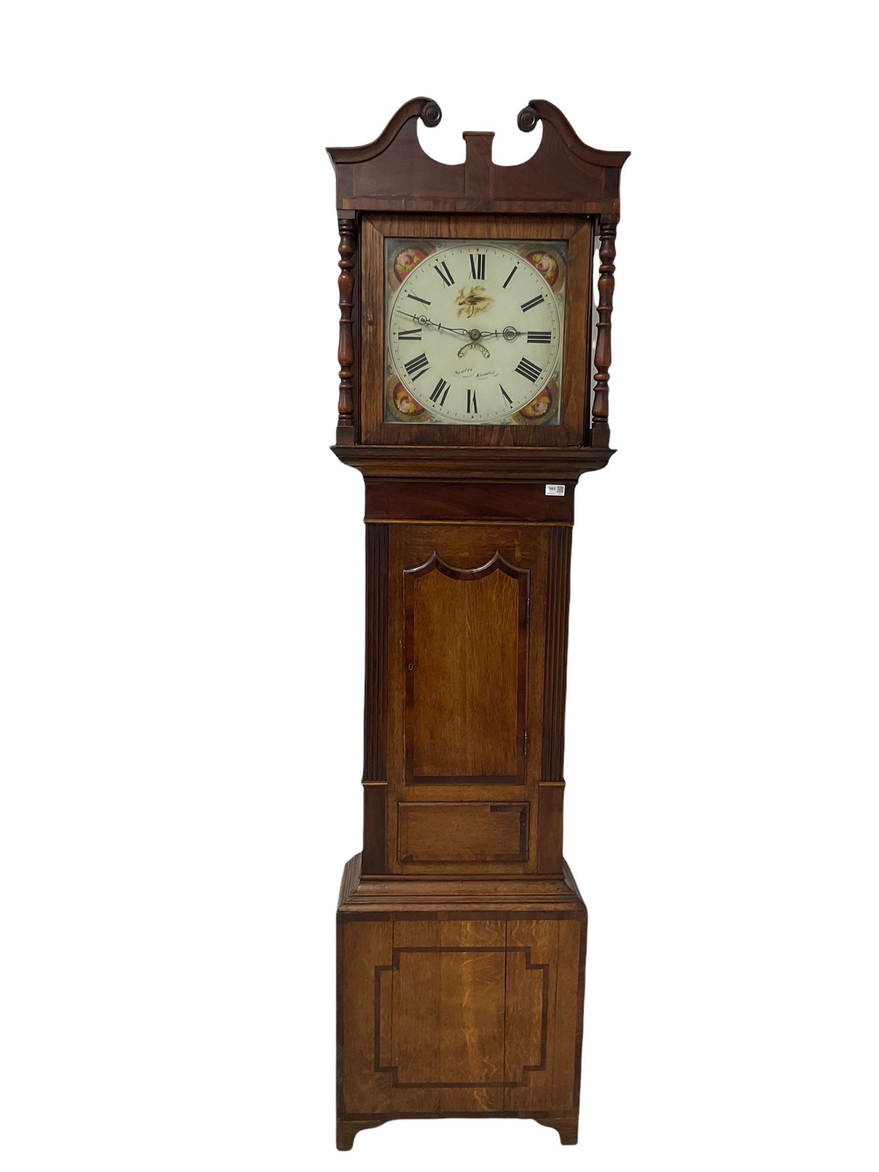 A mid-19th century oak cased longcase clock with a swan's neck pediment and wooden paterae