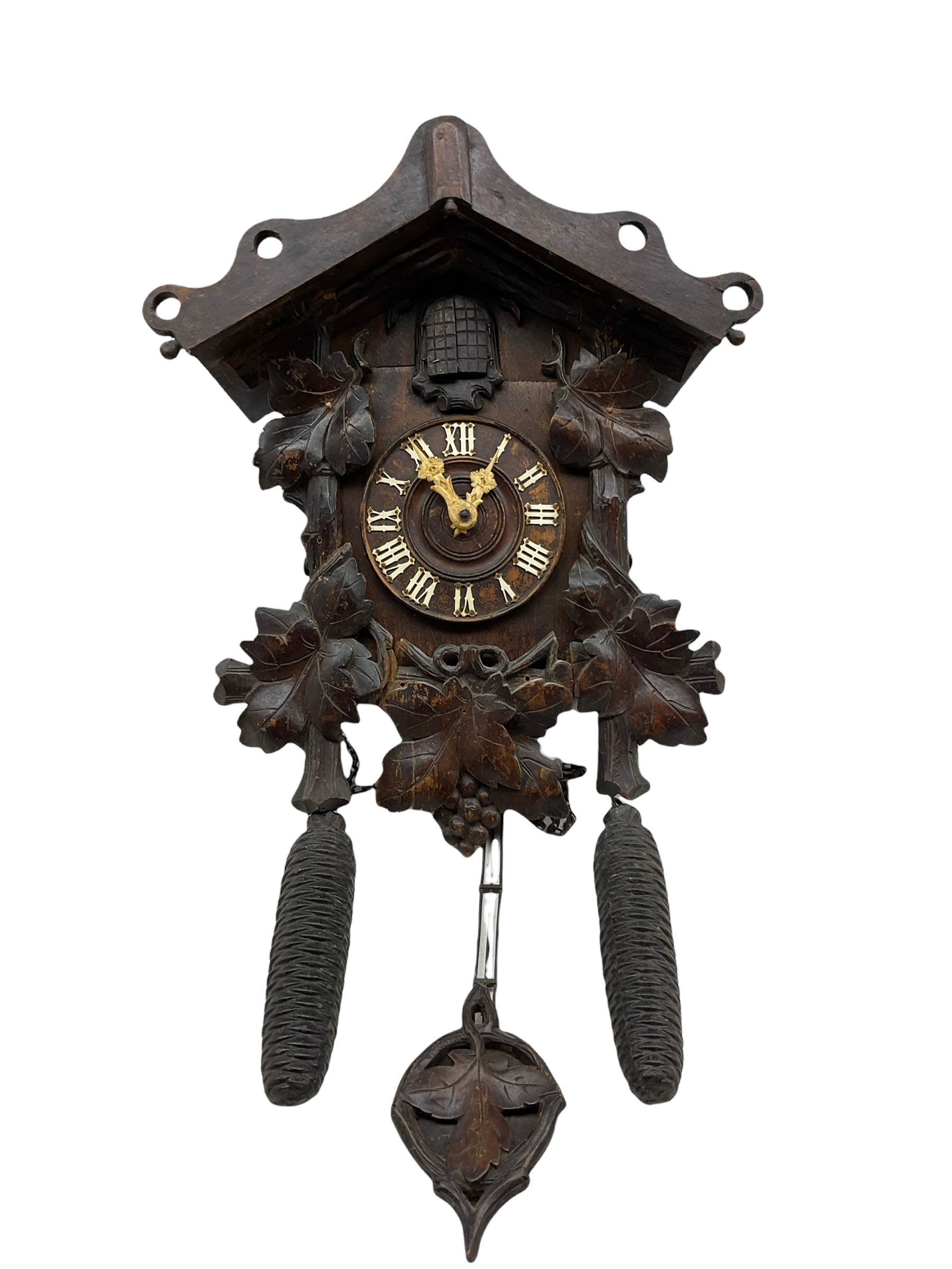 An early 19th century German Black Forest cuckoo clock in a carved oak case