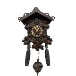 An early 19th century German Black Forest cuckoo clock in a carved oak case