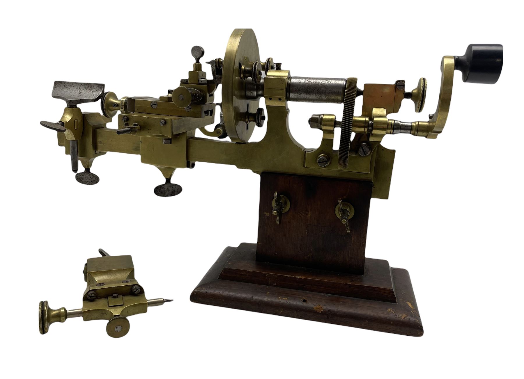 An early19th century hand operated brass watchmakers lathe in stained pine case