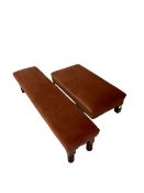 Two rectangular footstools upholstered in red fabric