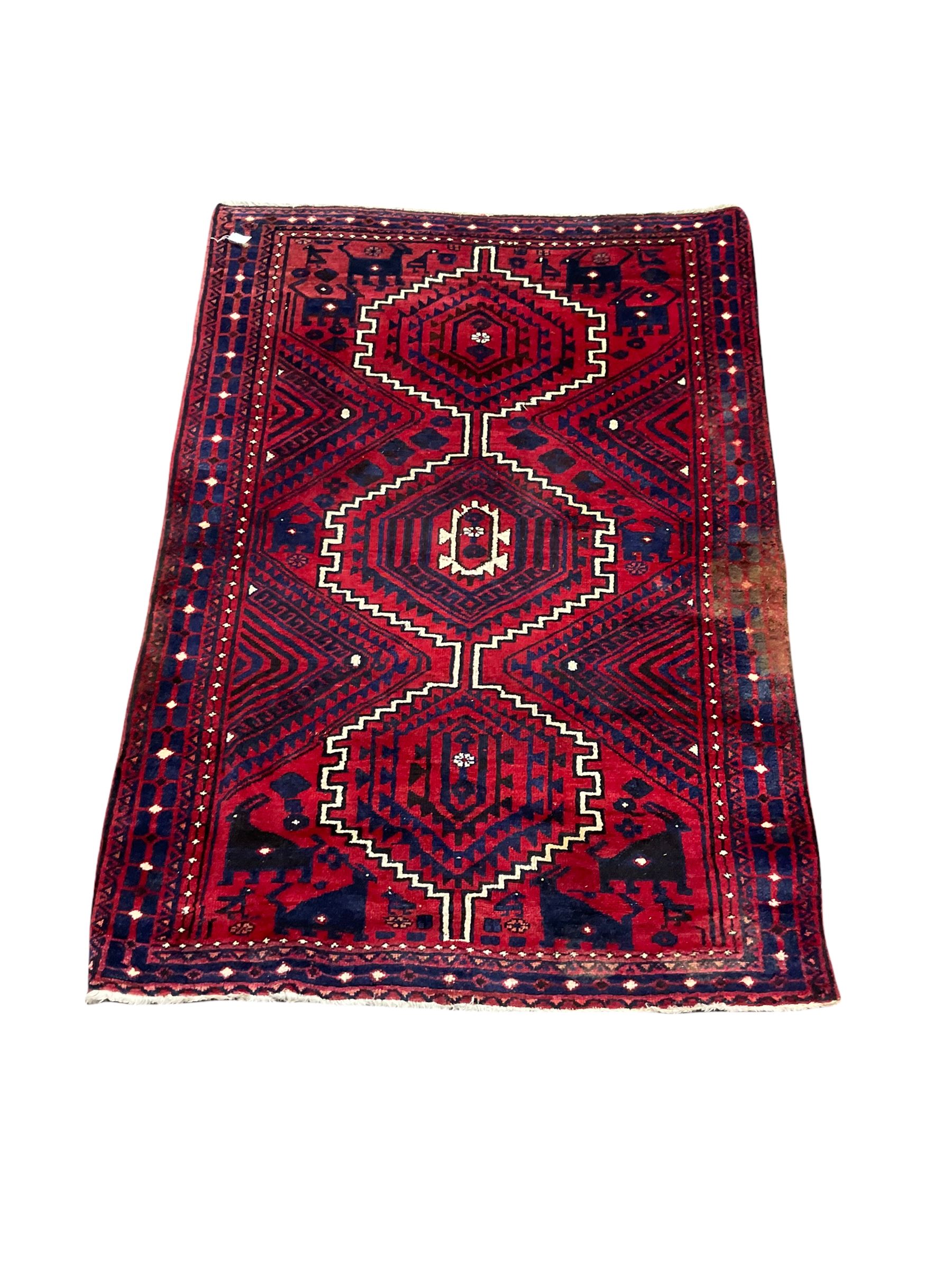 Persian design rug with three central medallions of geometric design with recurring animal motifs an