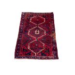 Persian design rug with three central medallions of geometric design with recurring animal motifs an