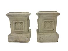 Pair of stone garden plinths with carved folate design