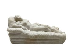 Carved alabaster nude figure reclining on a day bed