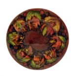 William Moorcroft plate decorated with the leaves and berries pattern