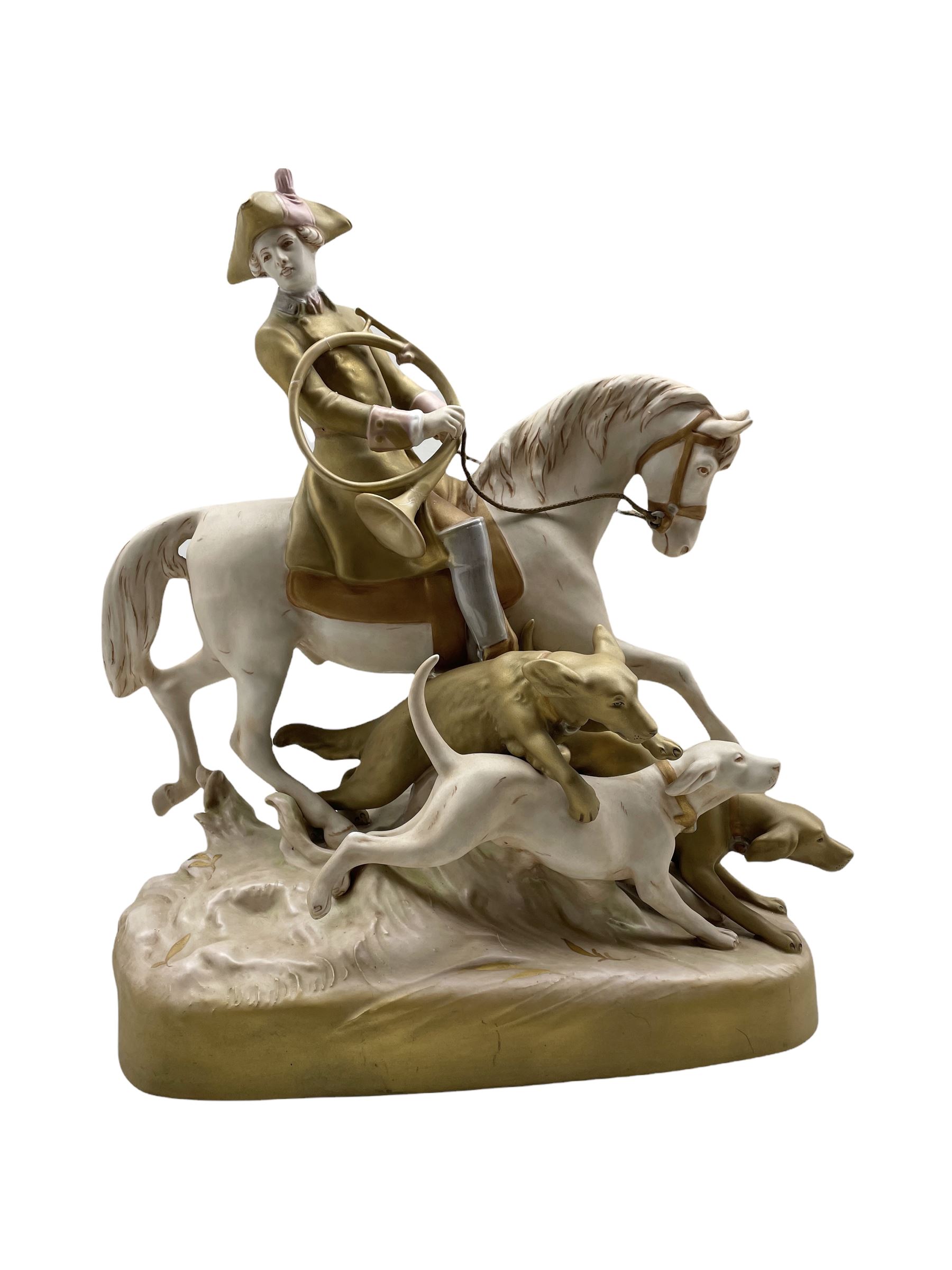 Large Royal Dux porcelain figure of a Huntsman on horseback with three hounds running alongside