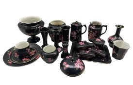 Collection of Carlton Ware items decorated with pink blossom on a black ground including dressing ta