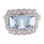 18ct white gold milgrain set three stone emerald cut aquamarine and round brilliant cut cluster ring