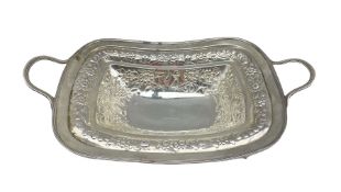 George III silver rectangular two handled fruit dish embossed with flower heads and leaves and with