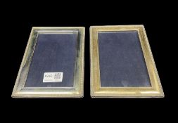 Pair of silver upright photograph frames with bead edge decoration and easel stands aperture size 15