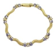 Yellow and white gold round tanzanite and diamond link bracelet