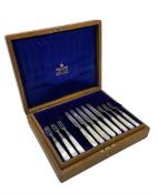 Set of eleven silver bladed dessert knives and twelve forks with mother of pearl handles in original