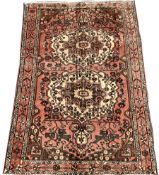 Vintage Persian faded red ground rug