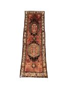 Persian runner rug of geometric design and ivory border