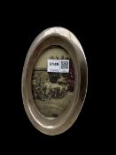 Silver oval photograph frame on easel stand