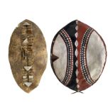 Zulu hide dance shield L91cm together with a Masai hide shield decorated in iron red