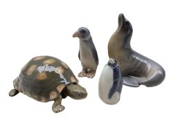 Four Royal Copenhagen porcelain animals comprising a Sea Lion no. 1441 and Penguin looking up no. 30