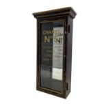 Ebonised display case with glazed door and later stencilled lettering 'Chanel No 5' 61cm x 30cm