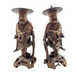 Pair of Chinese carved hardwood standing figures each holding prayer beads and on pierced bases H36c