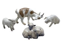 Two Royal Copenhagen porcelain figures comprising a pair of Lambs no. 2769 and a Pig no. 1400