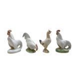 Three Royal Copenhagen porcelain Cockerels comprising 'Cock head down' no. 1127 and two 'Cock head u