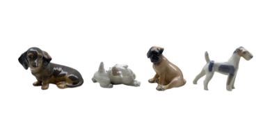 Four Royal Copenhagen porcelain dogs comprising a Boxer Puppy no. 3169