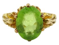 18ct gold oval peridot ring with leaf design gallery and shoulders