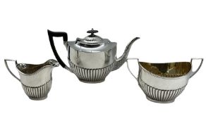 Silver three piece tea set of oval design with half body reeded decoration