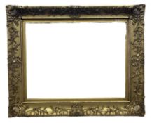 Early 20th century large gilt picture frame with flower head and foliate design