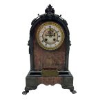 A late 19th century Belgium slate mantle clock with carved applied decoration to the arched top