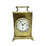 A French 19th century table clock in a decoratively engraved brass case on splayed bracket feet with