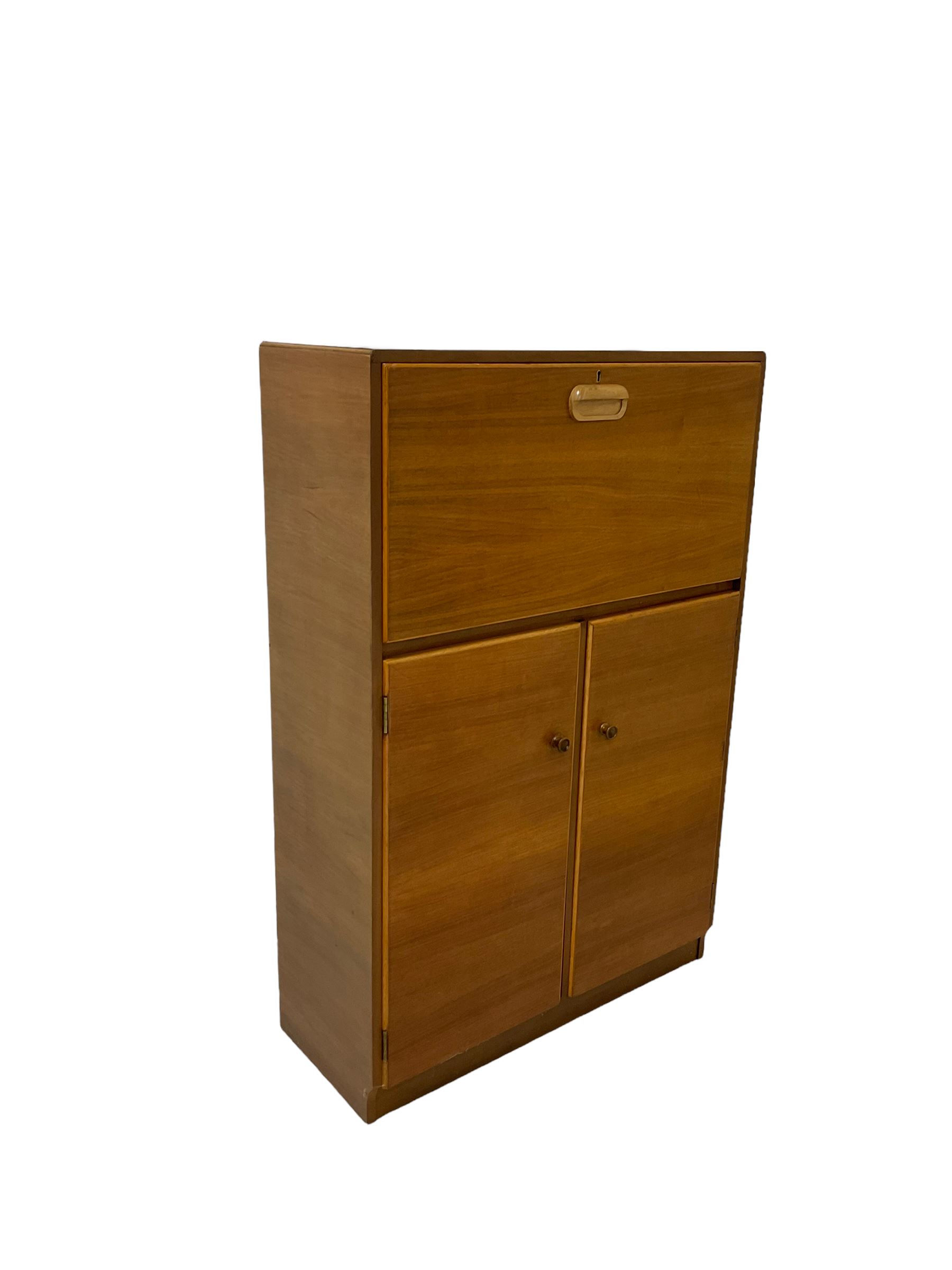Teak chest with one fall front drawer over two cupboards