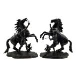 After Guillaume Coustou (1677-1746): Pair of bronze Marly horses with their groom