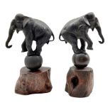 Pair of Japanese Meiji bronze elephants each balancing on a ball with a raised foreleg and on a wood